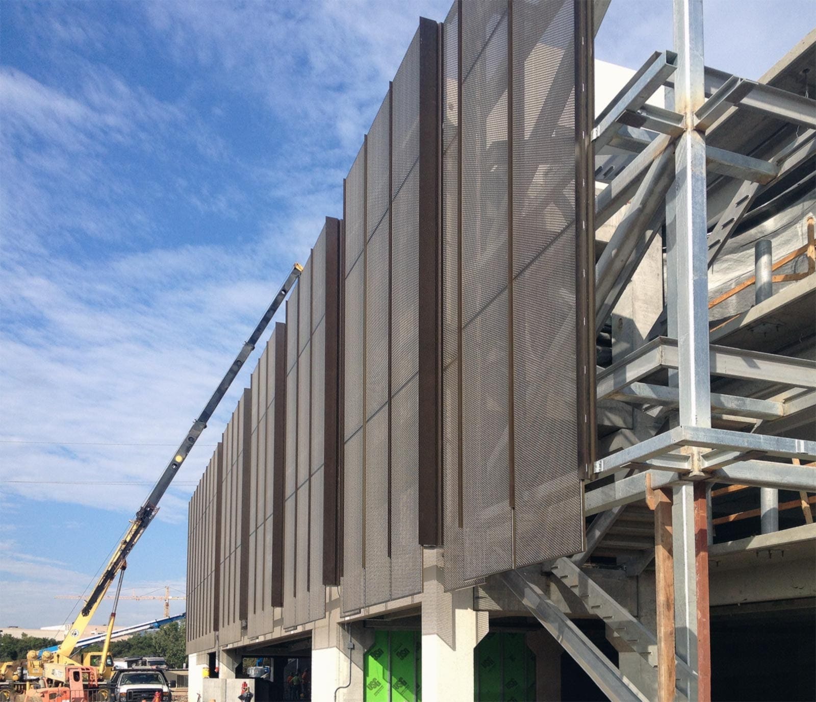 Construction photo of the perforated metal panel screen system at Stanford University Parking Garage.