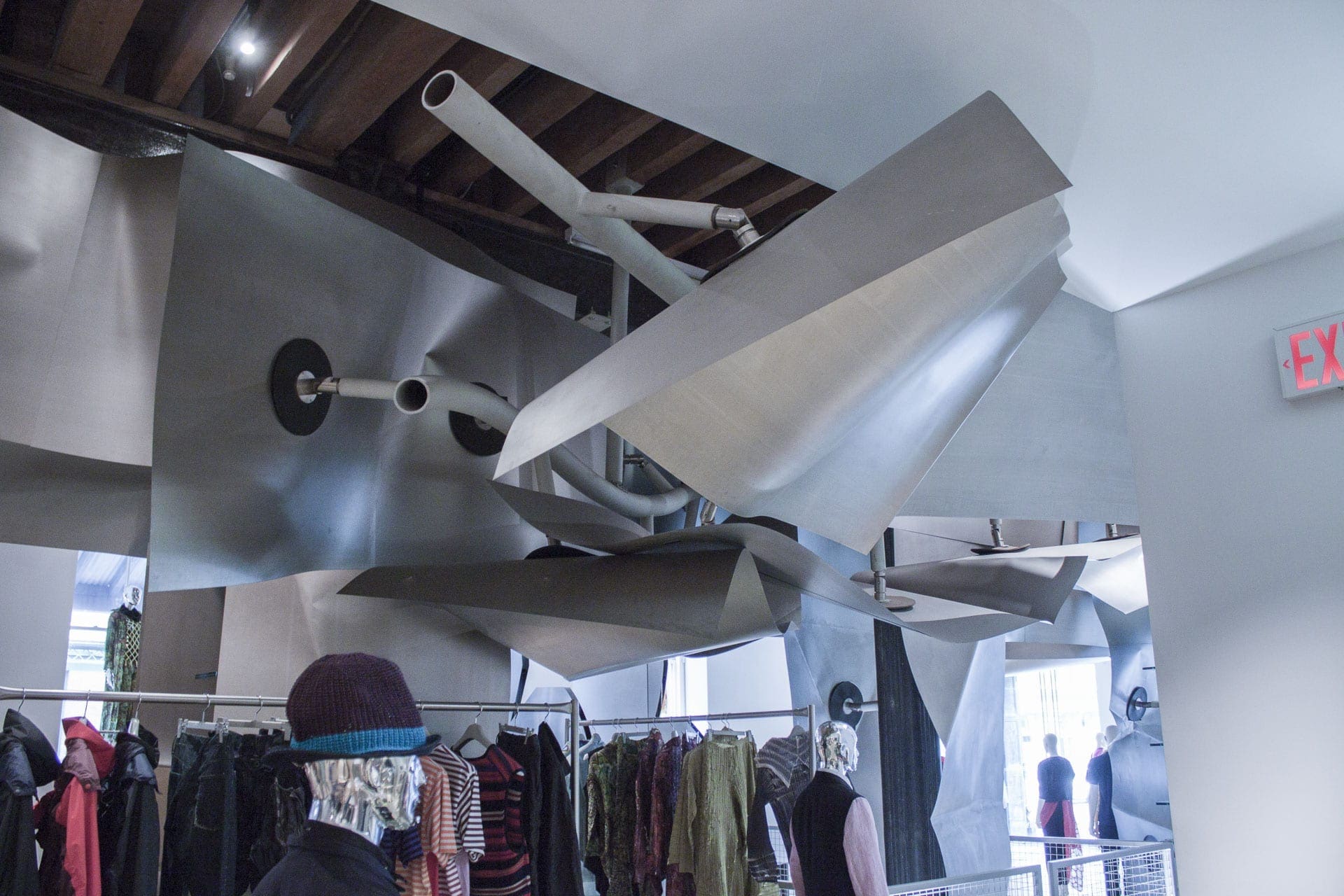 Curving titanium drop ceiling at Issey Miyake Tribeca.