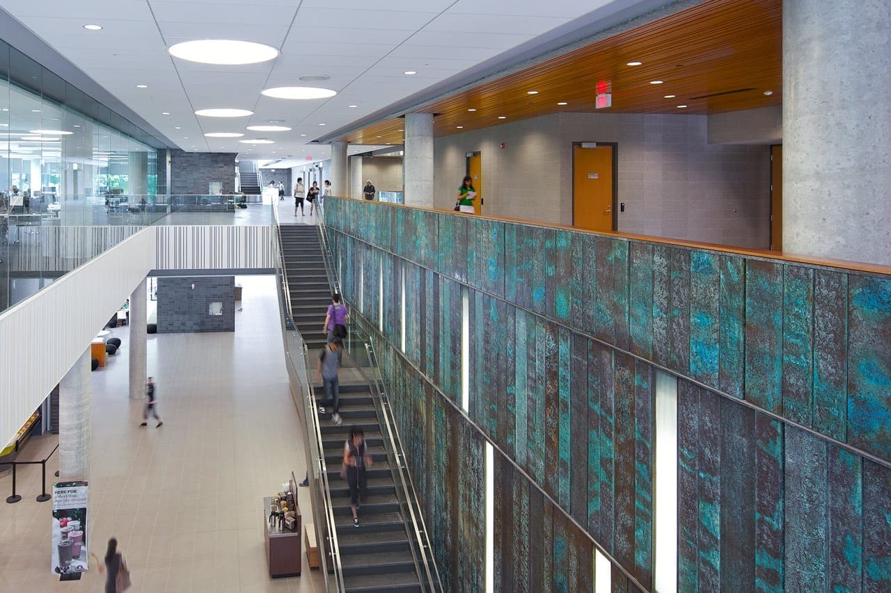 Students walk up and down the main staircase.