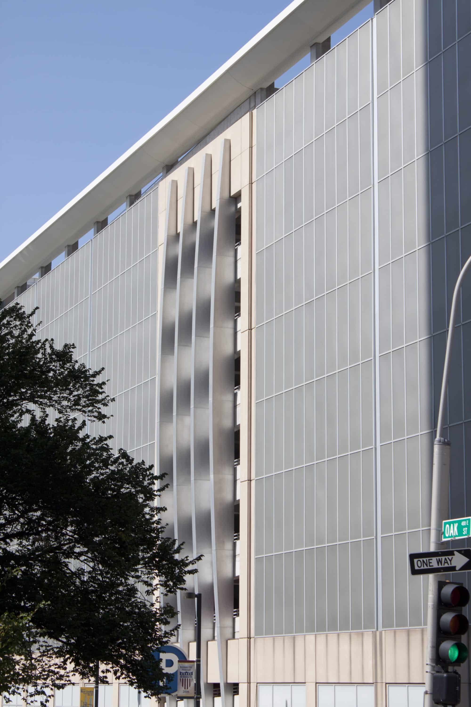 Four massive stainless steel-clad fins rise at the building's center.