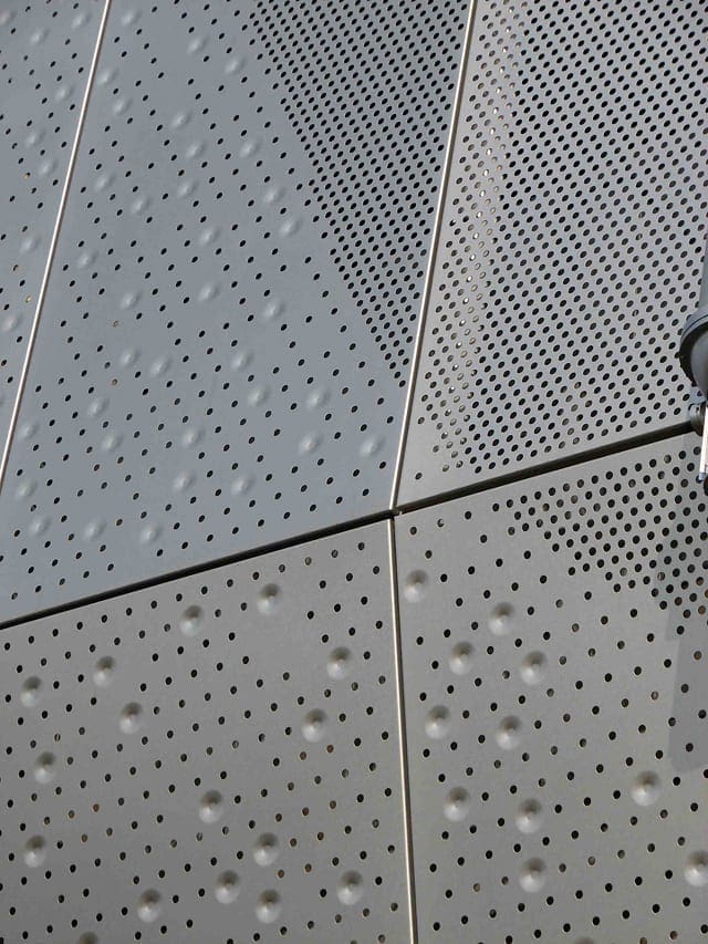 Detail of the perforated and embossed facade.