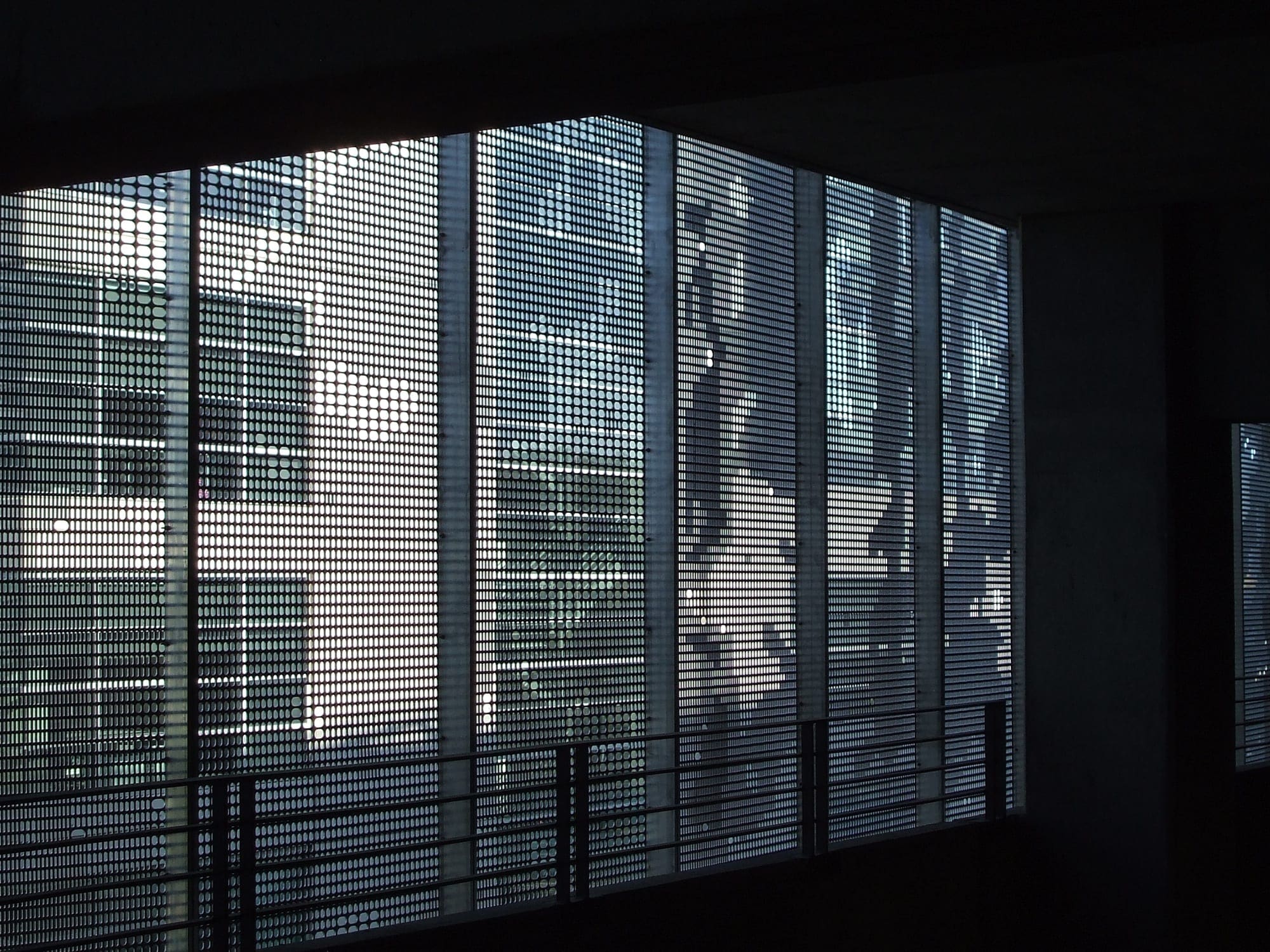 Detail of the perforated aluminum facade system from within the garage. 