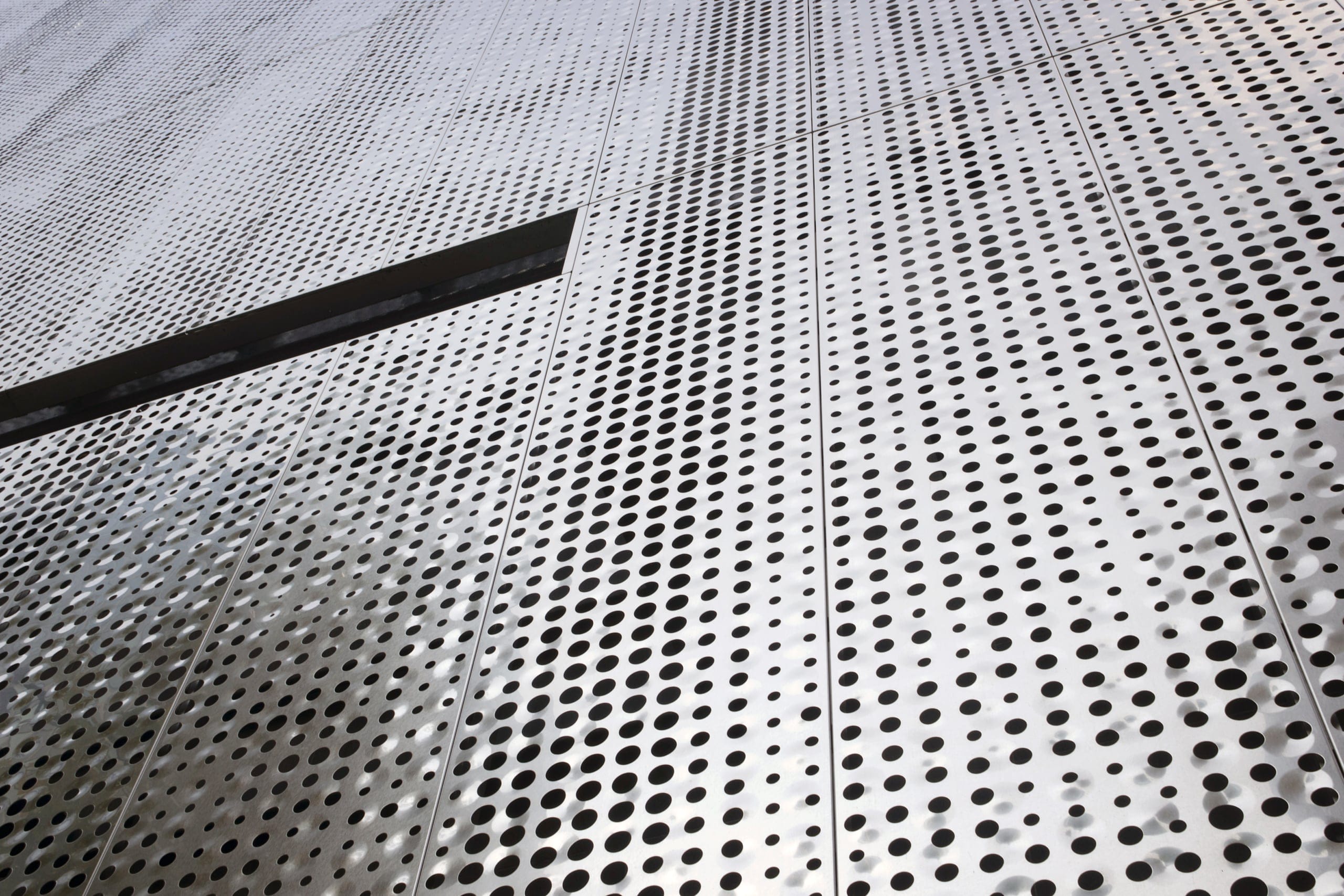 Detail of the custom perforated facade for Fairmont Pacific Rim.