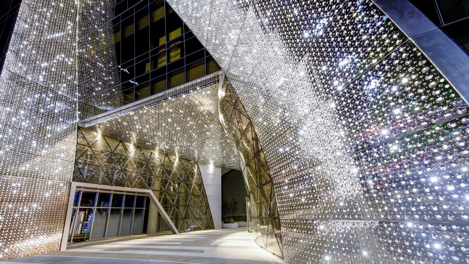 Harim Group Headquarters entrance has a curving stainless steel facade system made by Zahner.