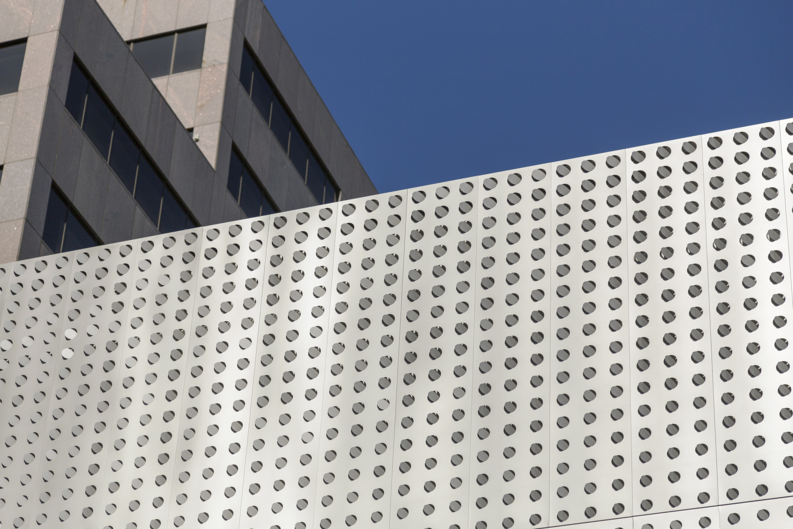 Sunlight activates the louvered perforated facade on the Dolby Labs Headquarters in San Francisco, California.