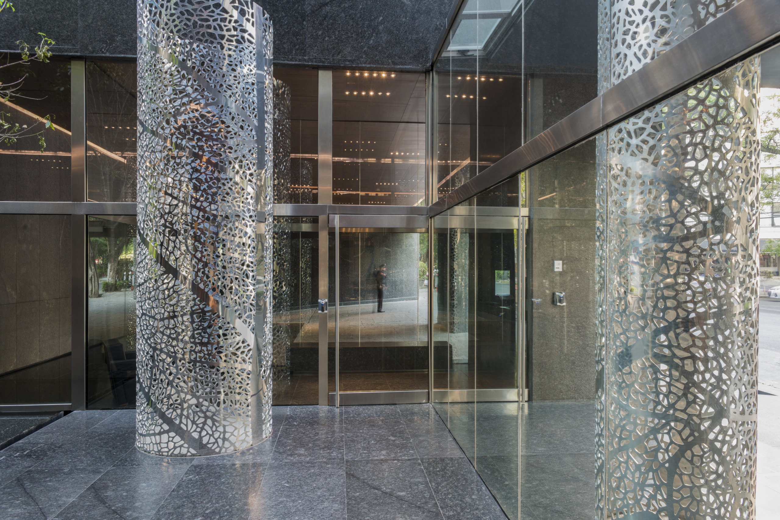 Perforated aluminum columns adorn the entrance of Artesia.