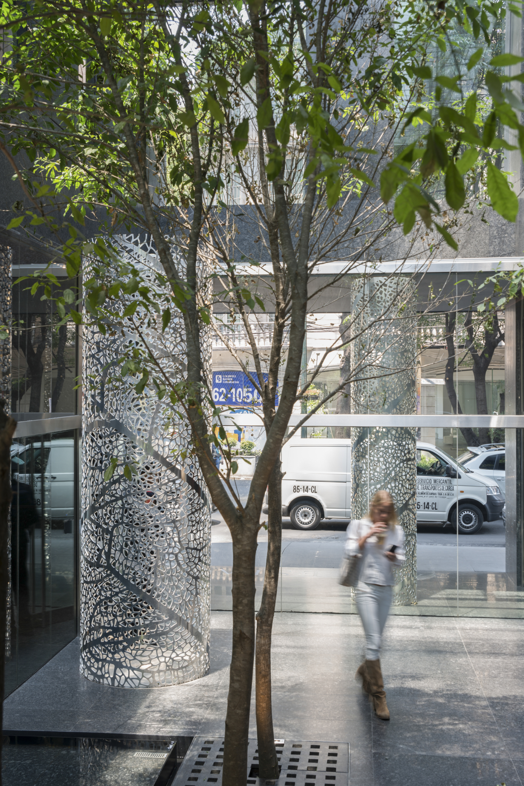 PERFORATED ALUMINUM COLUMNS ADORN THE ENTRANCE OF ARTESIA.