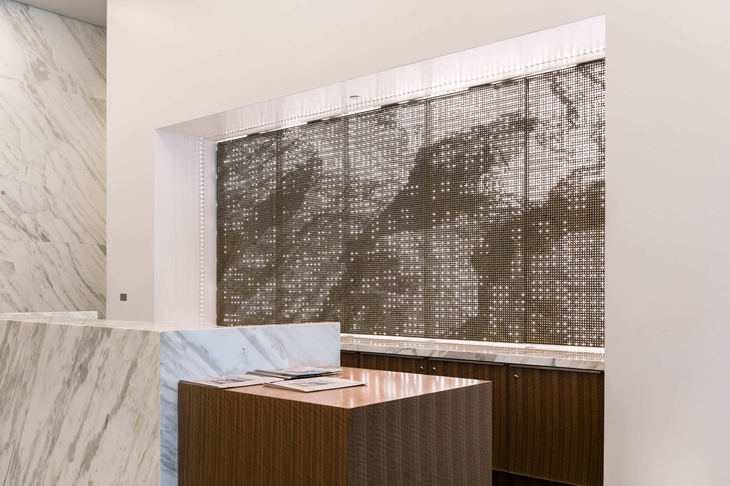 Interior perforated metal at the front desk for 1401 Lawrence.