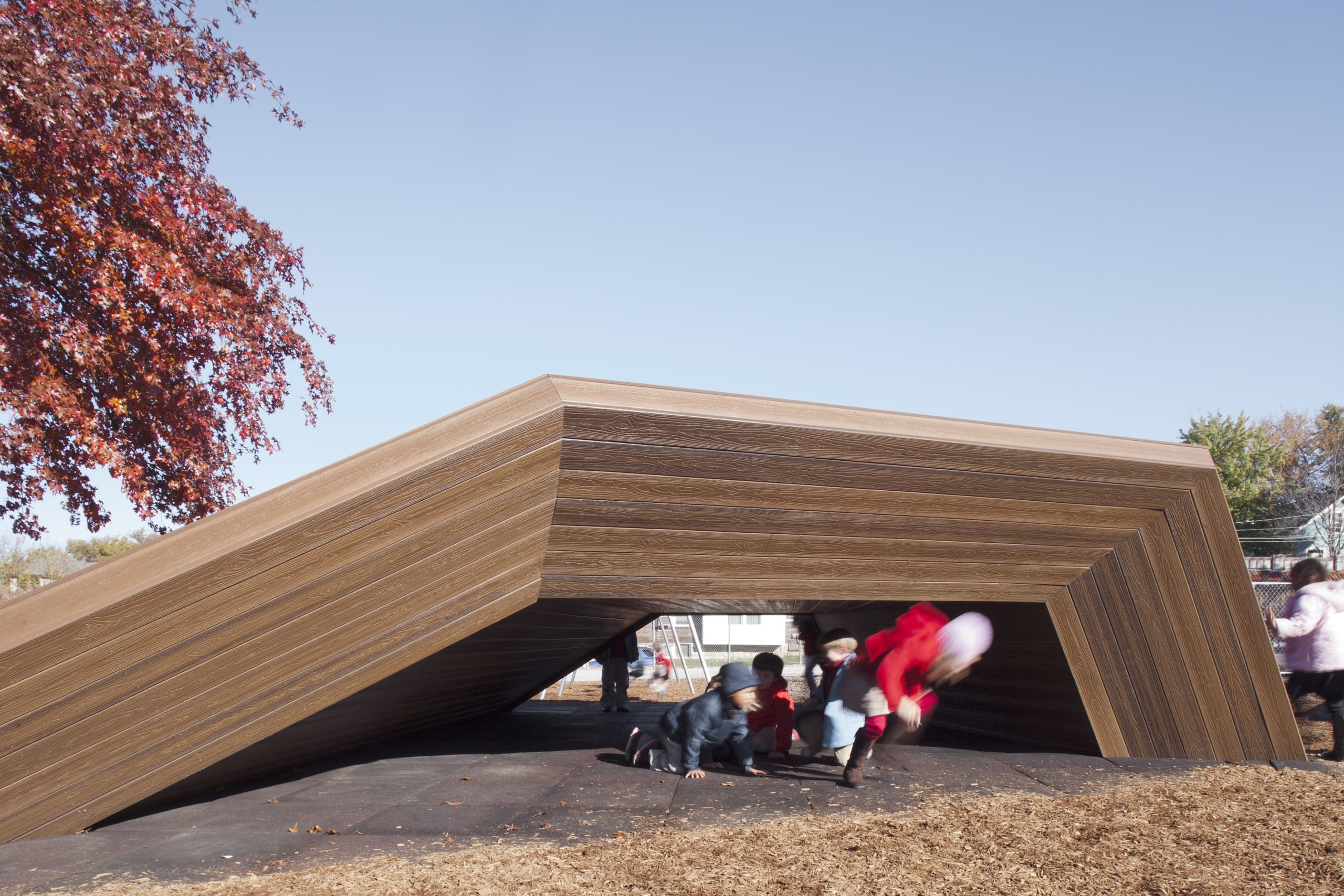 Children at Académie Lafayette play underneath the slide made by Zahner.