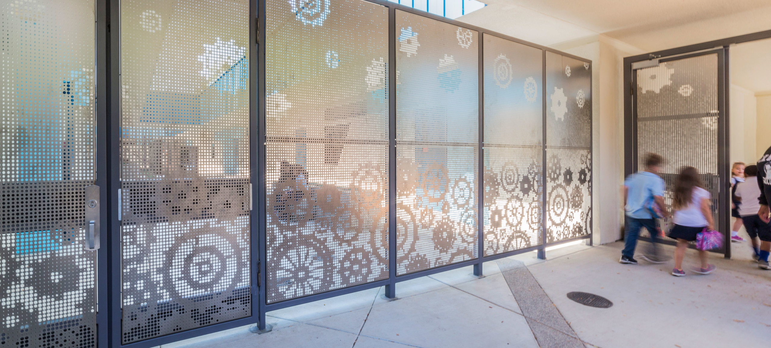 Perforations at the bottom of this fence are larger, while perforations at the top are smaller, making it harder for adults to see inside this elementary school in Sacramento.